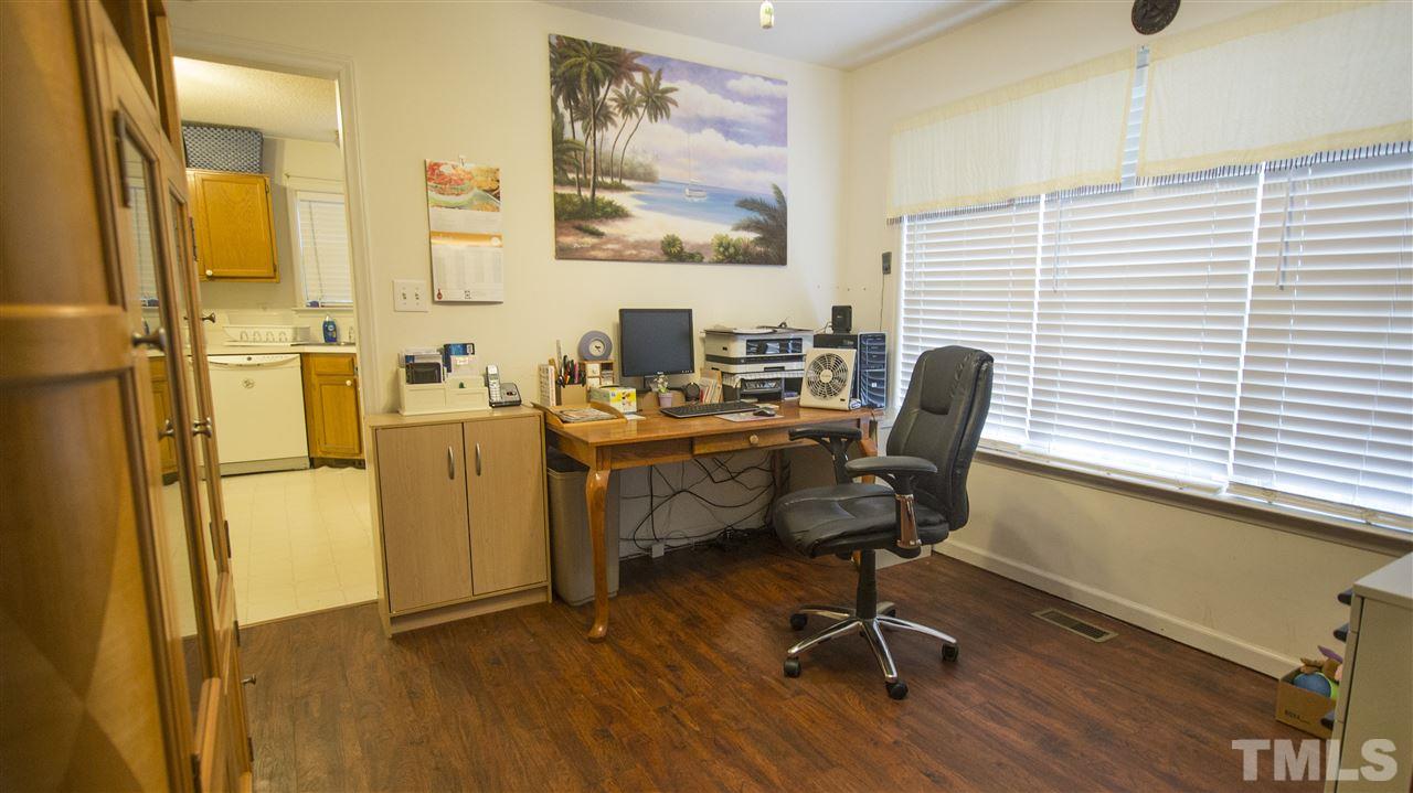 2829 Pinehurst Drive Raleigh, NC 27604 - Photo 7 of 16 a view of a workspace with furniture and a window
