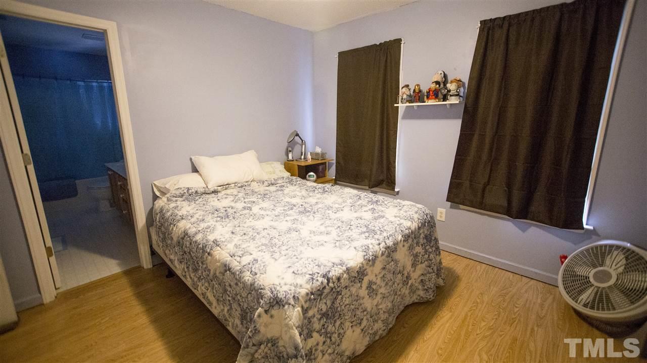 2829 Pinehurst Drive Raleigh, NC 27604 - Photo 10 of 16 a bed sitting in a bedroom next to a bathroom