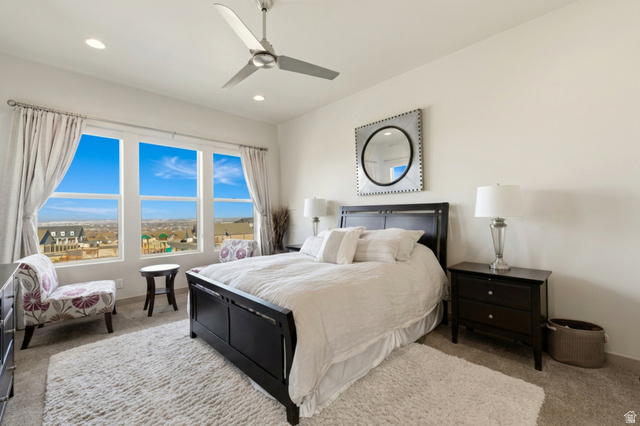 987 East Deer Arch Lane Draper, UT 84020 - Photo 22 of 46 Primary bedroom featuring large windows, light carpet, a ceiling fan, recessed lighting, and drape