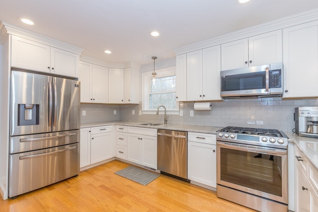 40 Allen Road Billerica, MA 01821 - Photo 3 of 32 a kitchen with granite countertop stainless steel appliances and wooden cabinets