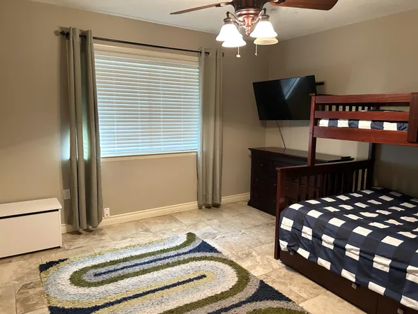 a bedroom with a bed and a flat screen tv