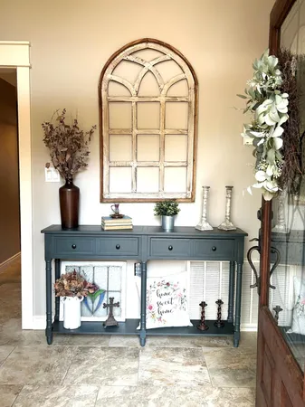 a kitchen with a large window and potted plant