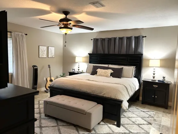 a bedroom with a bed and a chandelier