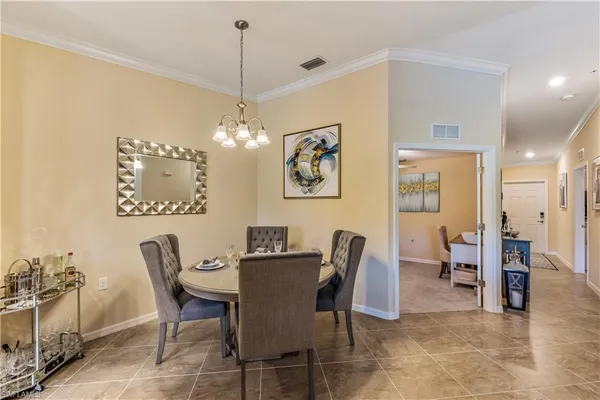 a view of a dining room with furniture and chandelier