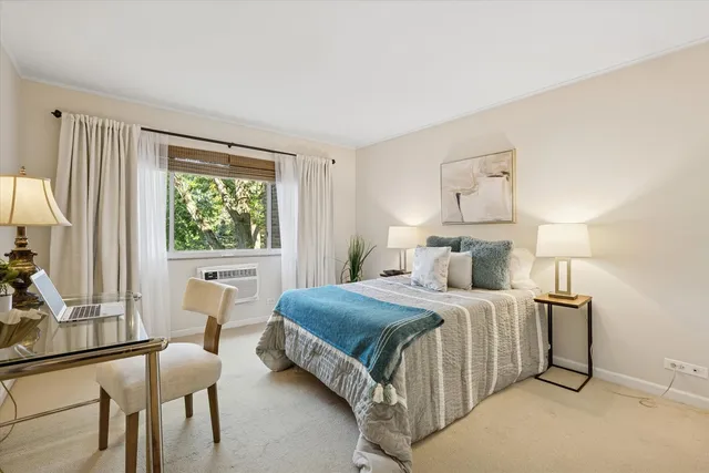 a bedroom with a bed a table and chair