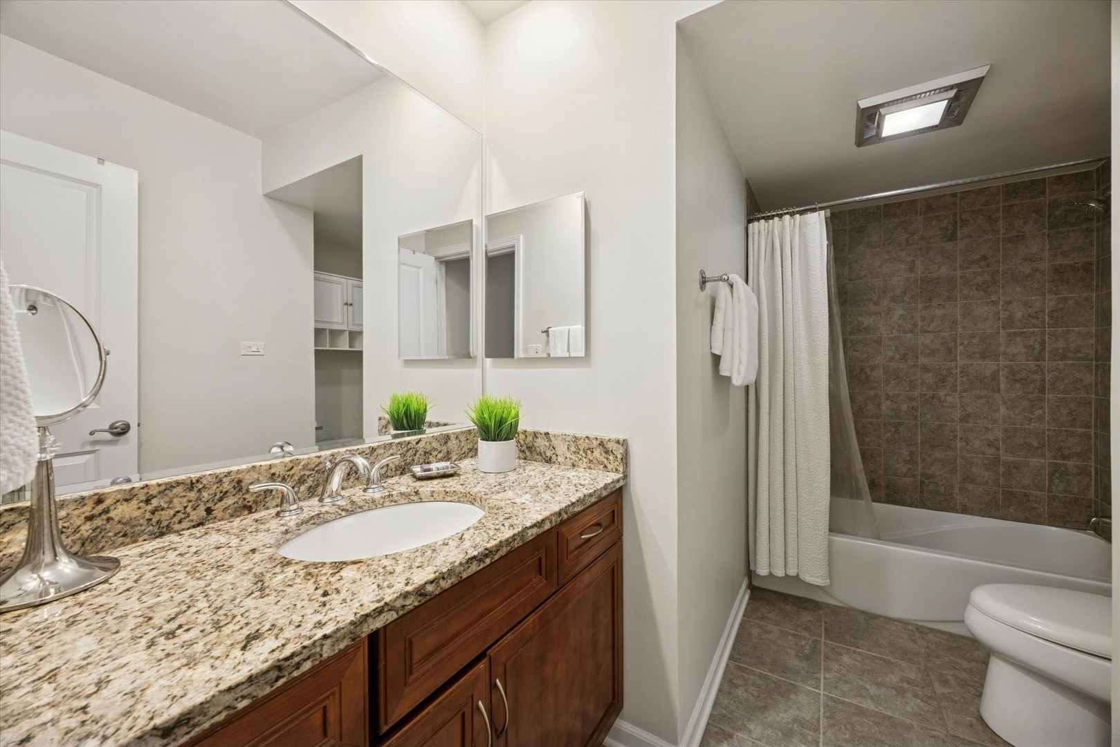 320 Claymoor, Unit 2D Hinsdale, IL 60521 - Photo 12 of 16 a bathroom with a granite countertop sink toilet and shower