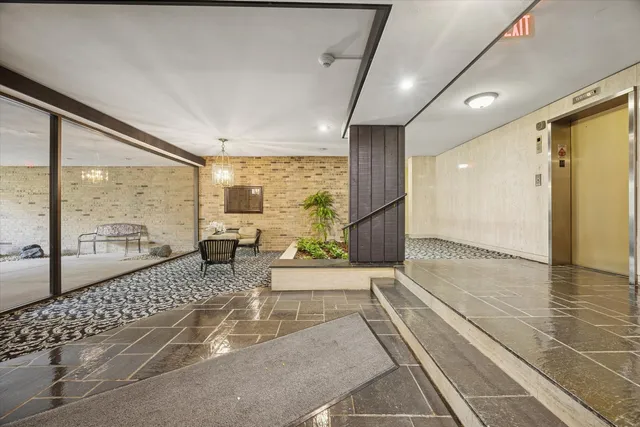 a lobby with furniture and floor to ceiling window