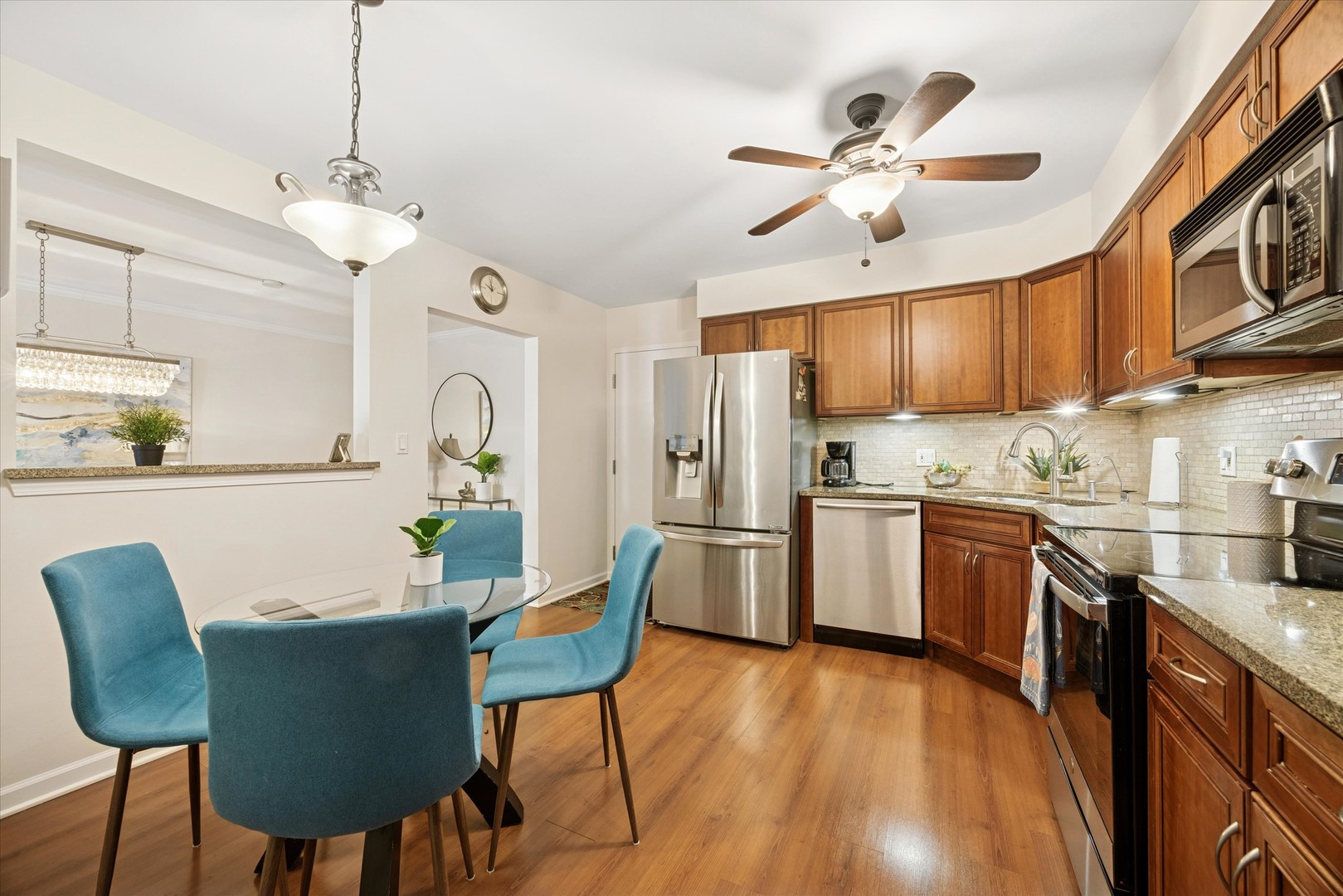 320 Claymoor, Unit 2D Hinsdale, IL 60521 - Photo 7 of 16 a kitchen with stainless steel appliances granite countertop a dining table chairs refrigerator and cabinets