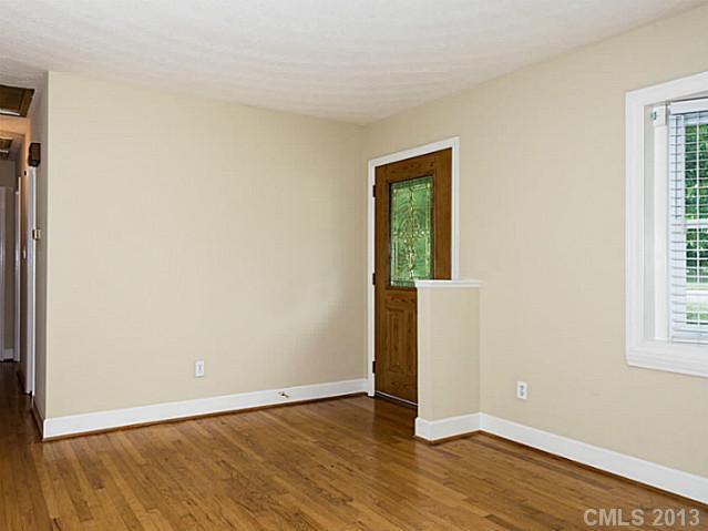 3860 Litchfield Road Charlotte, NC 28211 - Photo 3 of 11 an empty room with wooden floor and windows