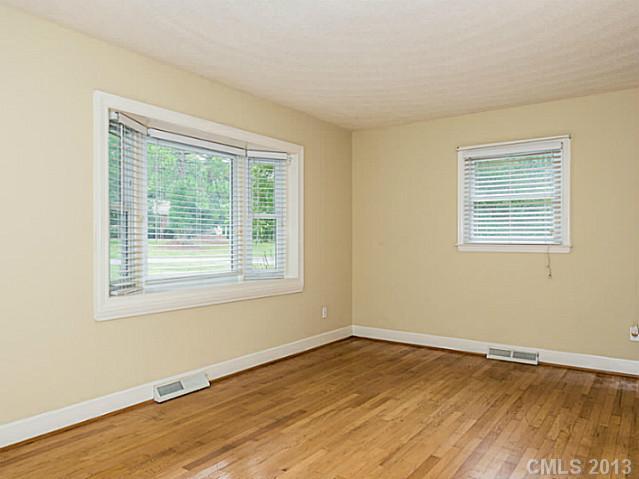 3860 Litchfield Road Charlotte, NC 28211 - Photo 4 of 11 a view of an empty room with wooden floor and a window
