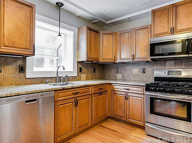 3860 Litchfield Road Charlotte, NC 28211 - Photo 5 of 11 a kitchen with stainless steel appliances granite countertop a sink stove and microwave