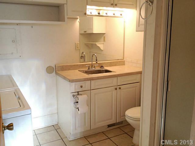 3860 Litchfield Road Charlotte, NC 28211 - Photo 7 of 11 a bathroom with a sink a toilet and a mirror