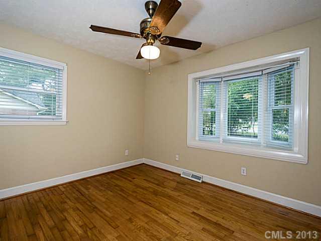 3860 Litchfield Road Charlotte, NC 28211 - Photo 8 of 11 a view of an empty room with wooden floor and a window