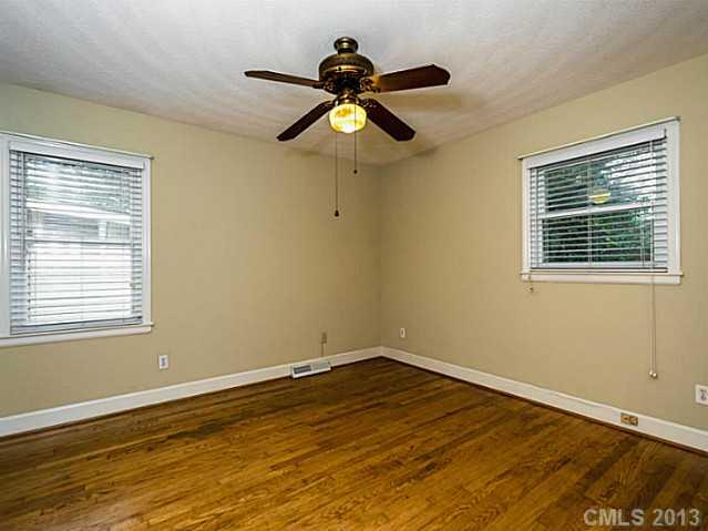 3860 Litchfield Road Charlotte, NC 28211 - Photo 10 of 11 a view of empty room with wooden floor and fan