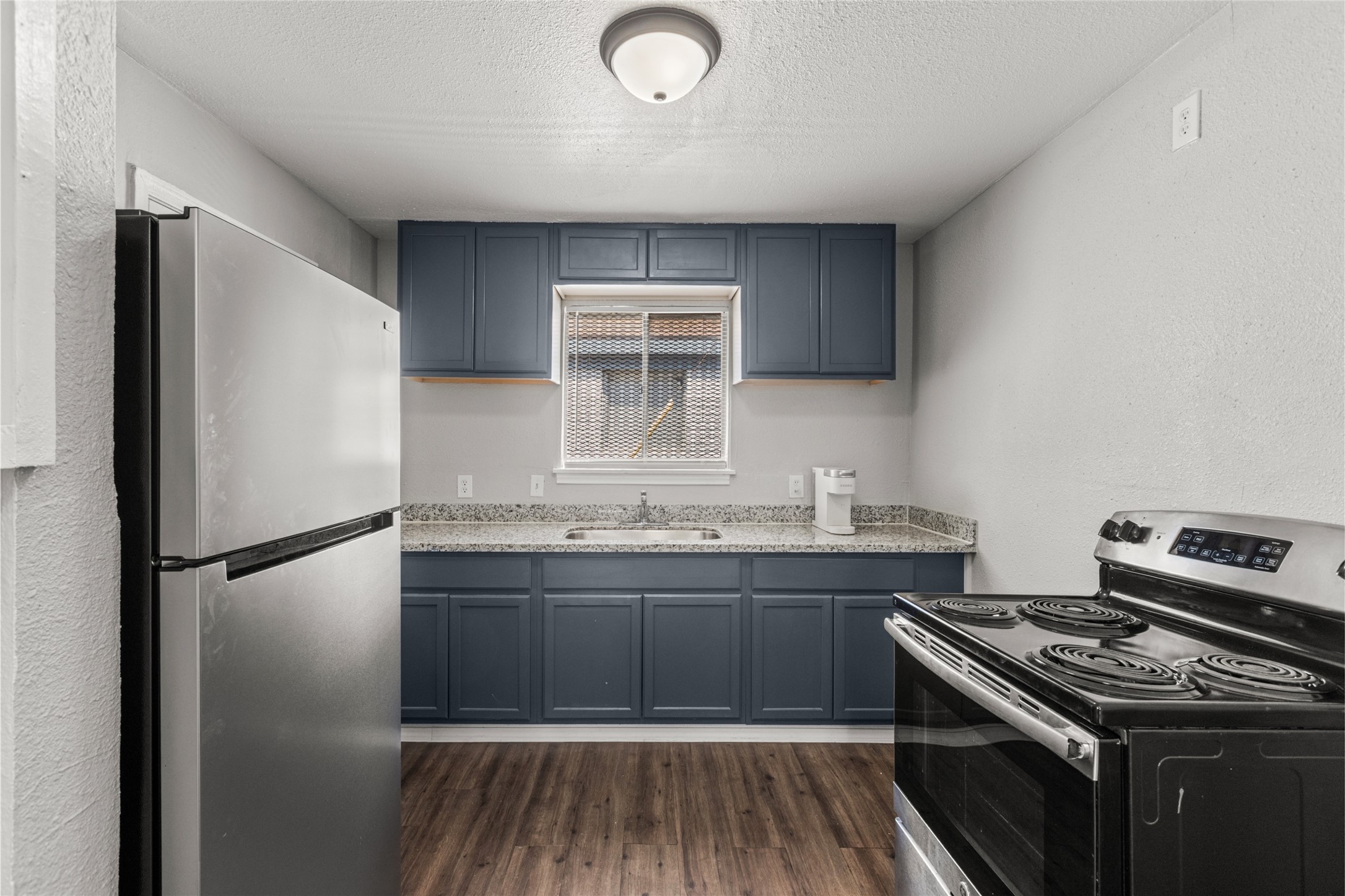 5718 Pickfair Street, Unit 4 Houston, TX 77026 - Photo 2 of 13 a kitchen with a sink stove and refrigerator