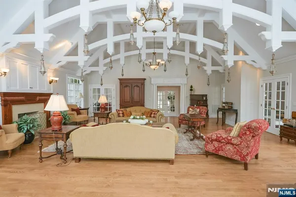 a living room with furniture a chandelier and a fireplace