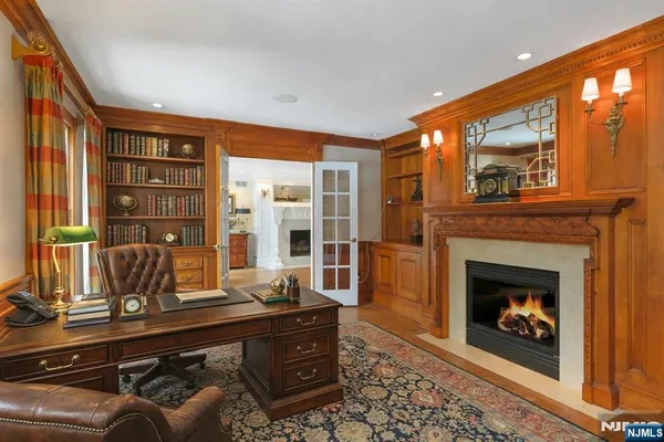 a living room with furniture a fireplace and a floor to ceiling window