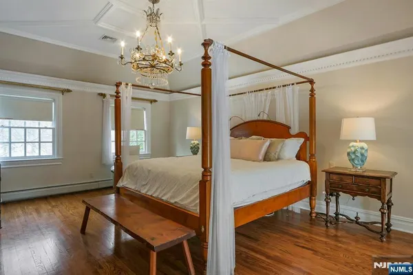 a bedroom with a bed and a chandelier