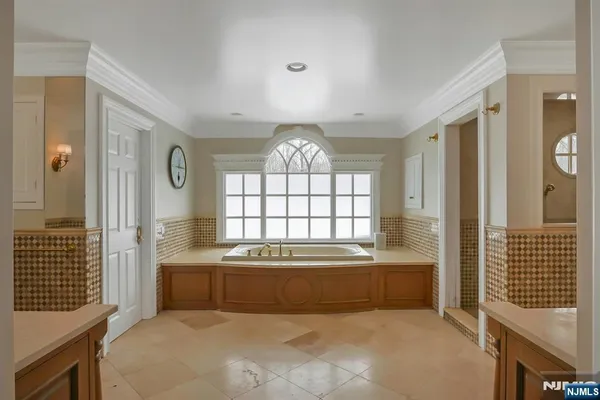 a en suite bathroom with a bathtub sink and mirror