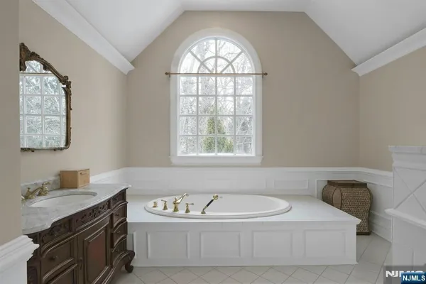 a bathroom with a bathtub a sink and a window