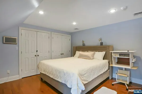 a bedroom with a bed and a chair