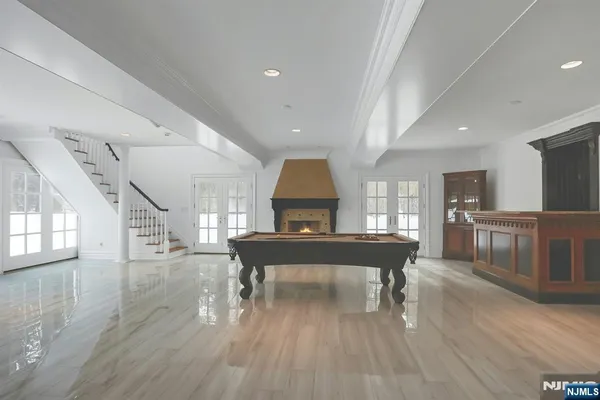 a living room with furniture a piano and wooden floor