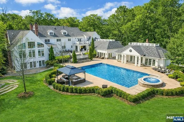 an aerial view of a house with swimming pool garden and patio