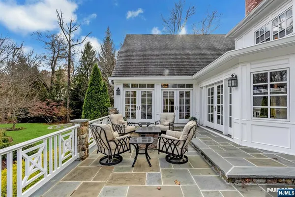 a view of a patio with couches table and chairs and potted plants