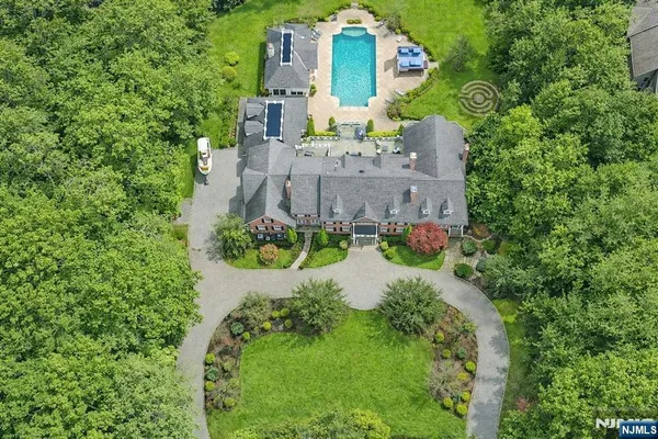 an aerial view of a house with a yard