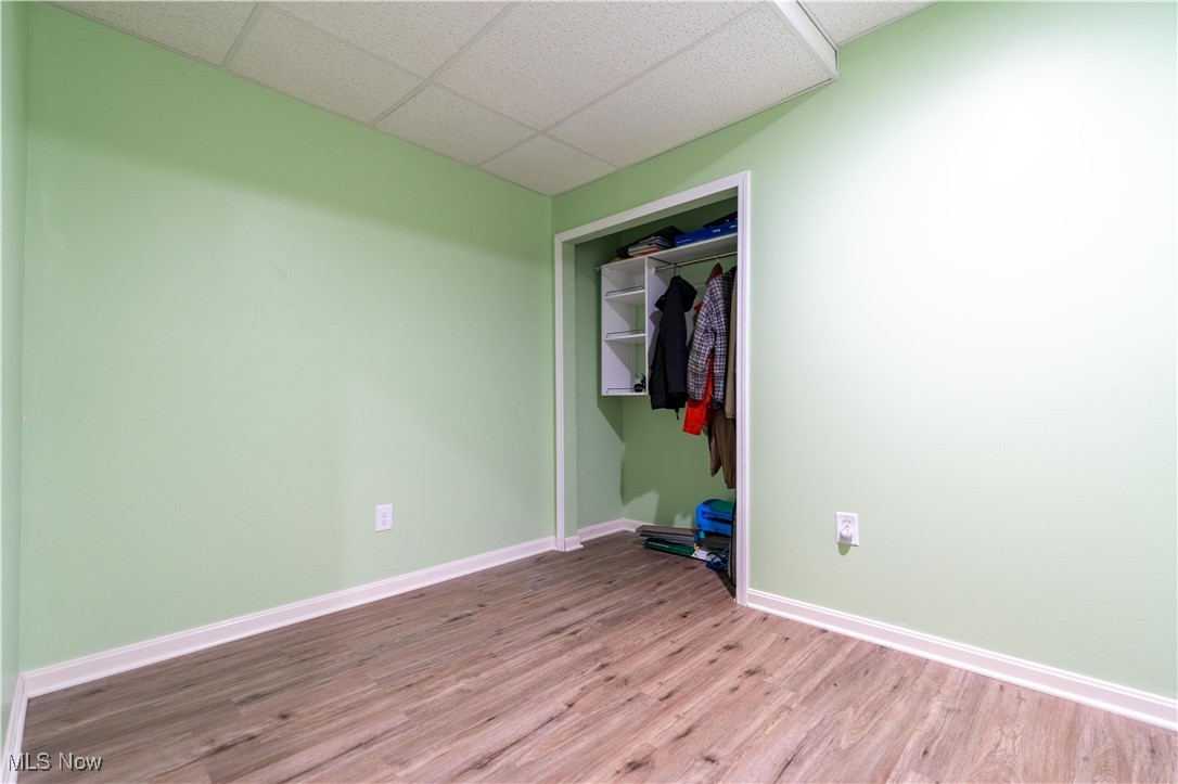 2542 Call Road Stow, OH 44224 - Photo 19 of 47 Unfurnished bedroom featuring a paneled ceiling, a closet, and light wood-type flooring