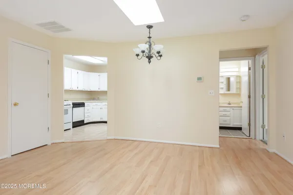 a view of a room with cabinet and a chandelier