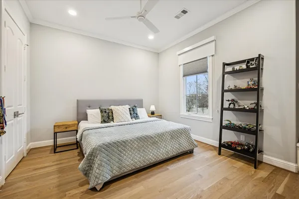 a bedroom with a bed and a window