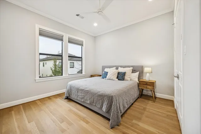 a bedroom with a large bed and a window