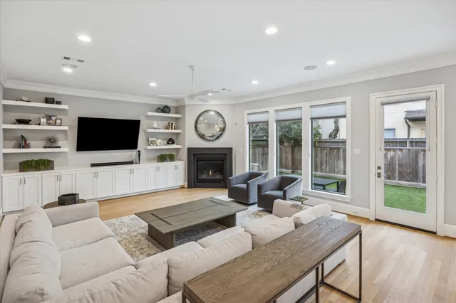 a living room with fireplace furniture and a flat screen tv