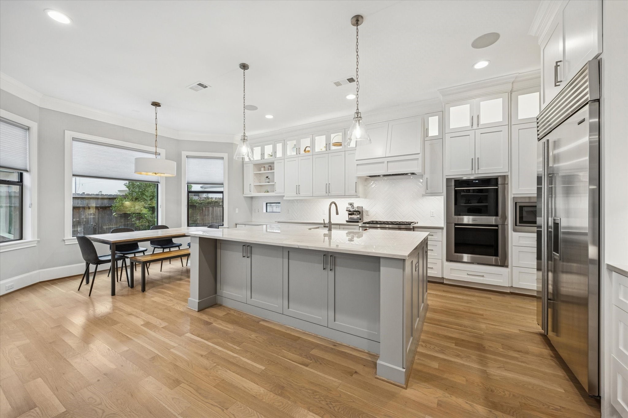 4108 Sunset Boulevard Houston, TX 77005 - Photo 8 of 21 a large kitchen with kitchen island a large counter top stainless steel appliances and cabinets