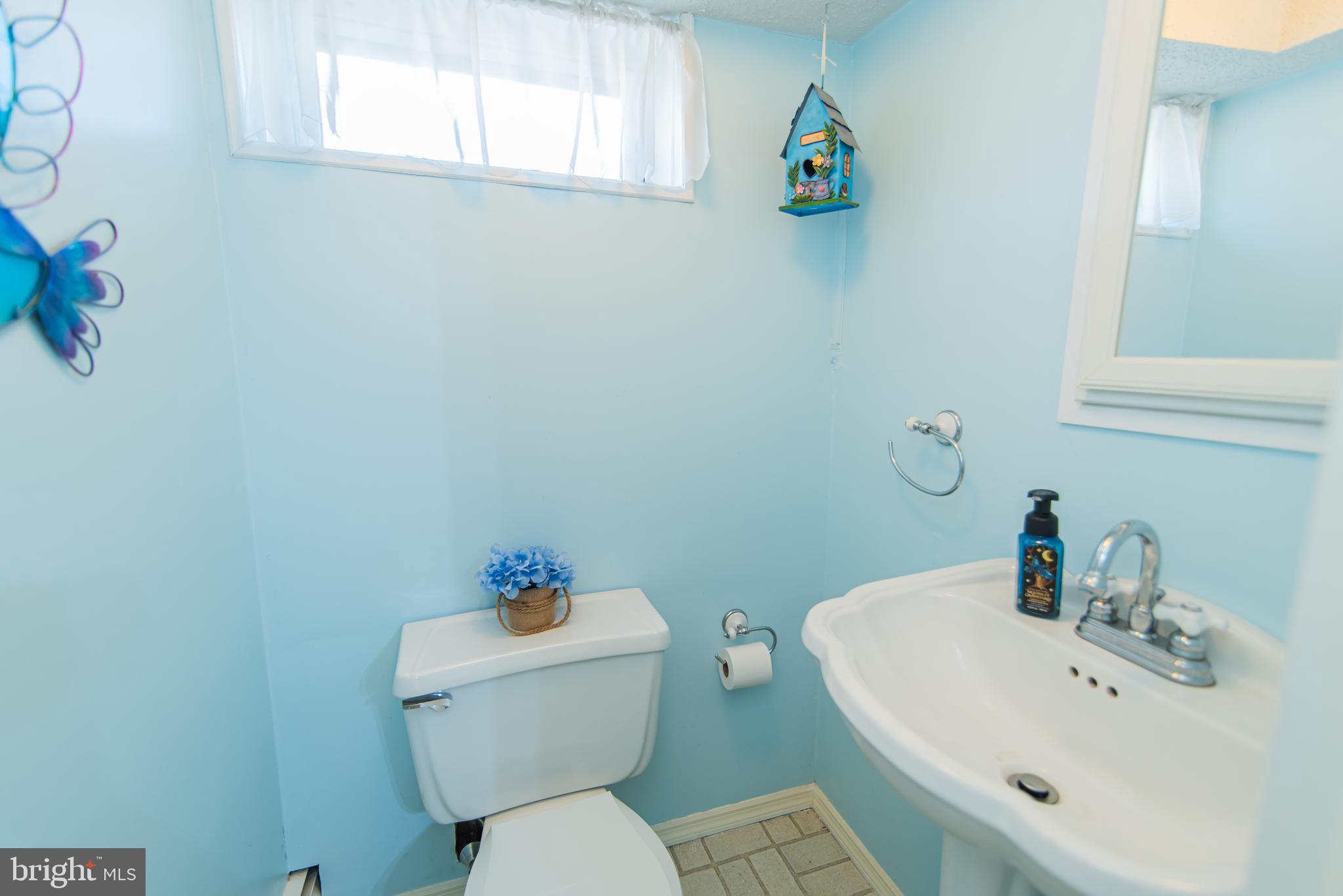 3239 Byberry Road Philadelphia, PA 19154 - Photo 46 of 51 a bathroom with a sink mirror a toilet and a window