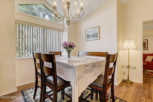 a view of a dining room with furniture and wooden floor
