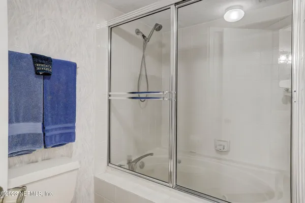 a bathroom with a shower and a sink