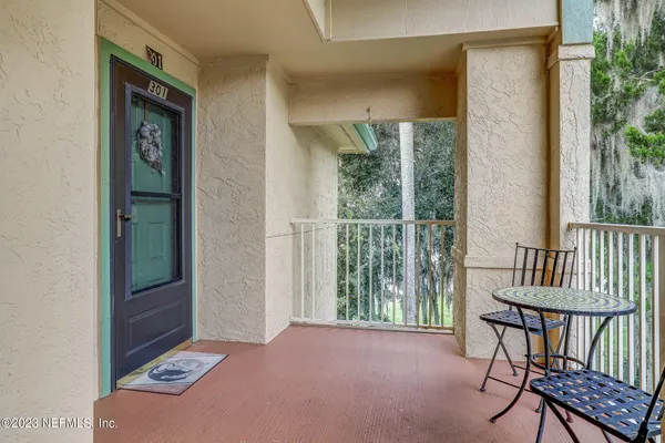 a view of a hallway with furniture and front door