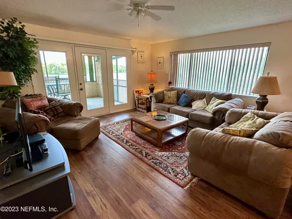 a living room with furniture rug and a large window