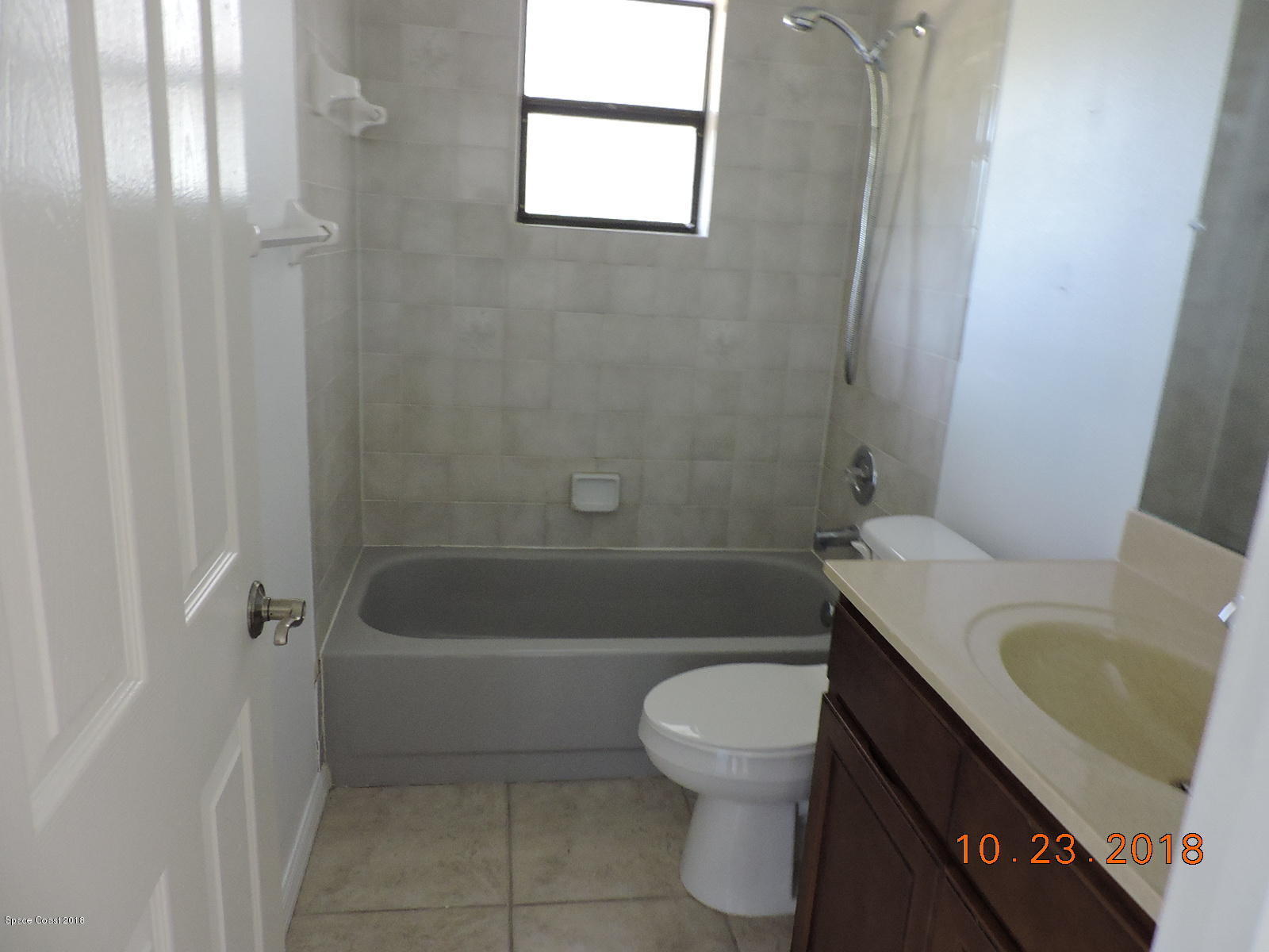2195 Ladner Road Northeast Palm Bay, FL 32907 - Photo 12 of 14 a bathroom with a sink a toilet and shower