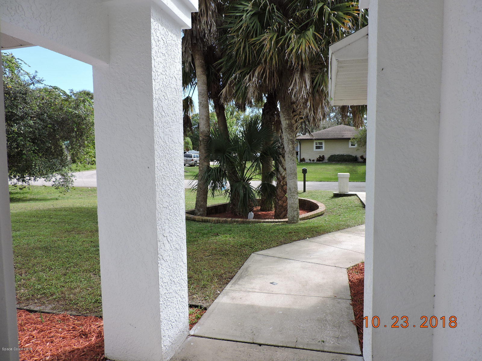 2195 Ladner Road Northeast Palm Bay, FL 32907 - Photo 2 of 14 a view of a yard in front of a house with a fountain