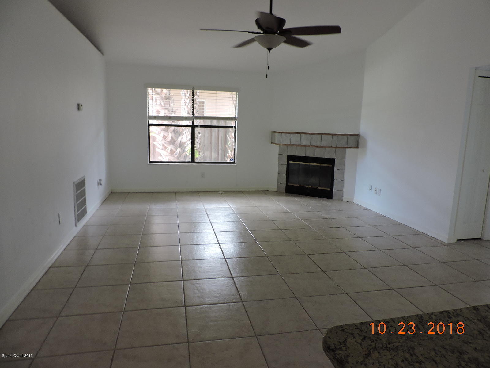 2195 Ladner Road Northeast Palm Bay, FL 32907 - Photo 4 of 14 an empty room with windows and fireplace