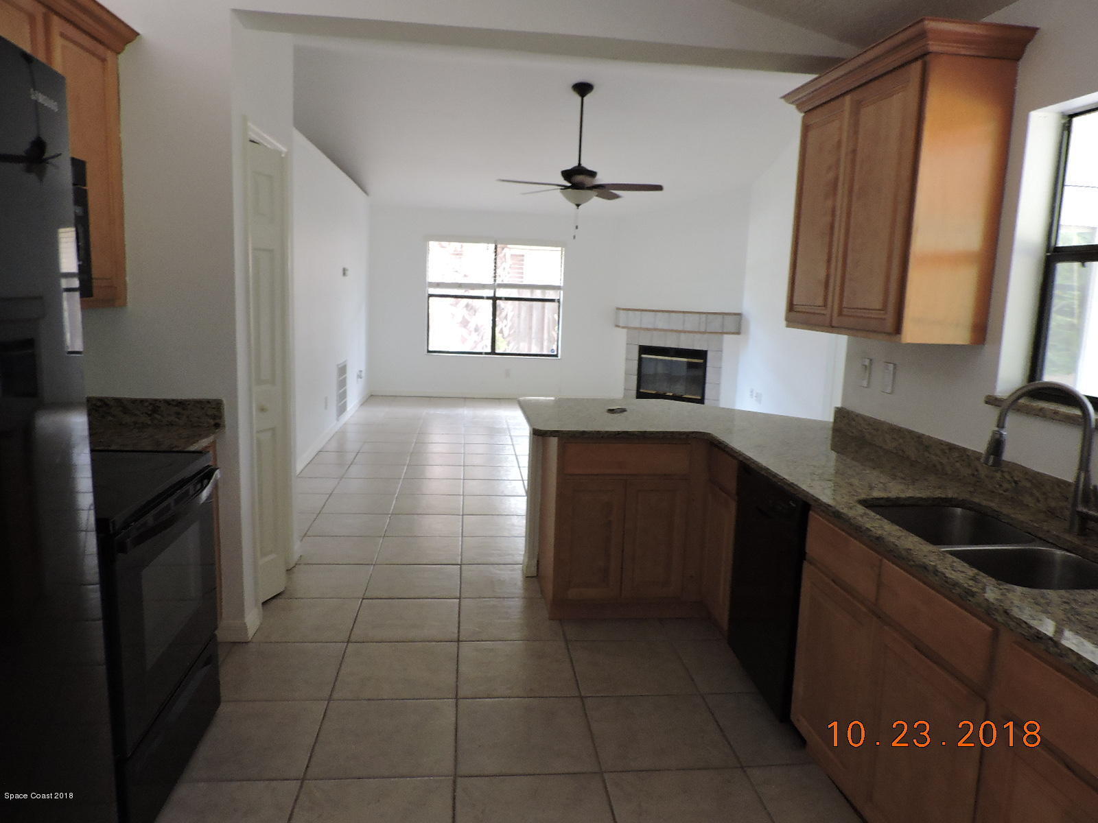 2195 Ladner Road Northeast Palm Bay, FL 32907 - Photo 5 of 14 a kitchen with a sink a stove and cabinets