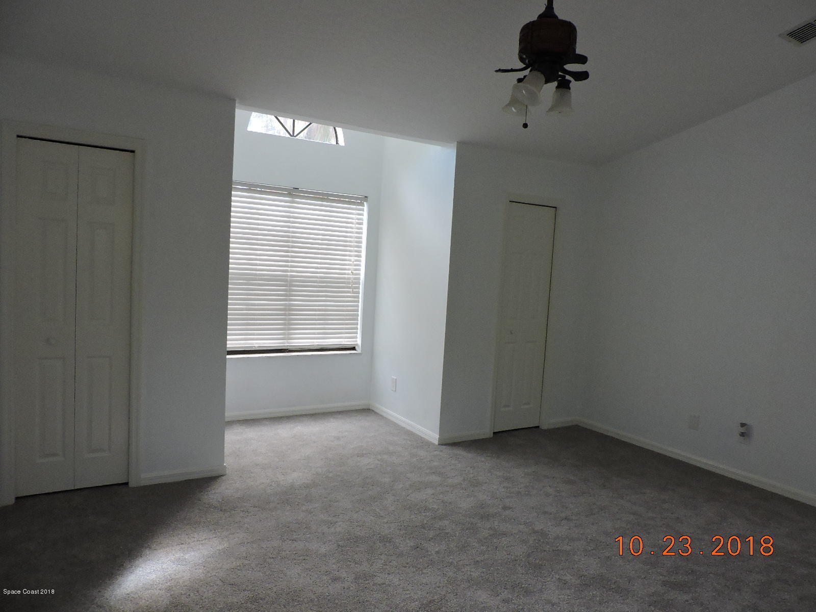 2195 Ladner Road Northeast Palm Bay, FL 32907 - Photo 8 of 14 an empty room with a empty space and windows