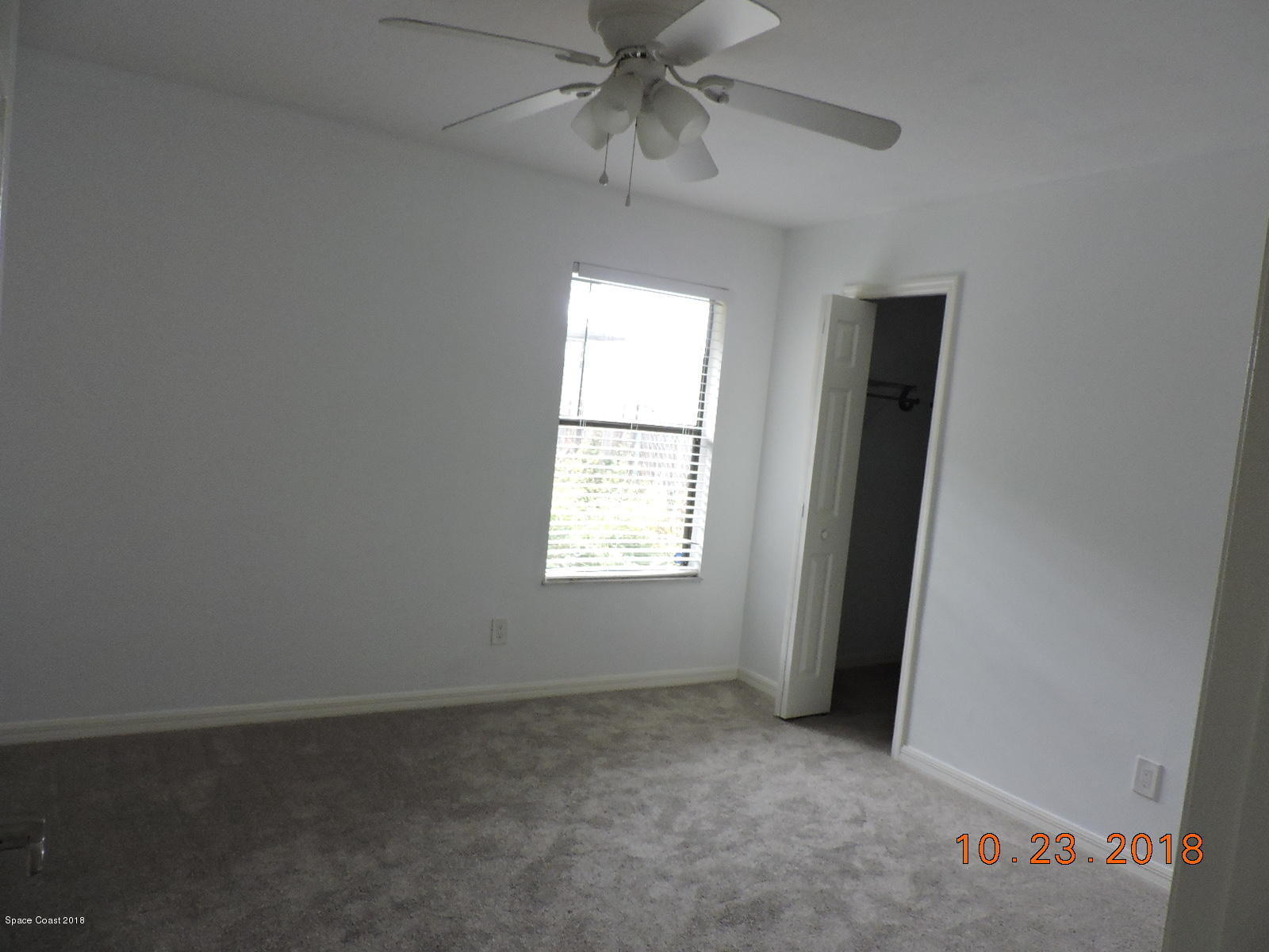 2195 Ladner Road Northeast Palm Bay, FL 32907 - Photo 10 of 14 an empty room with a window and a fan