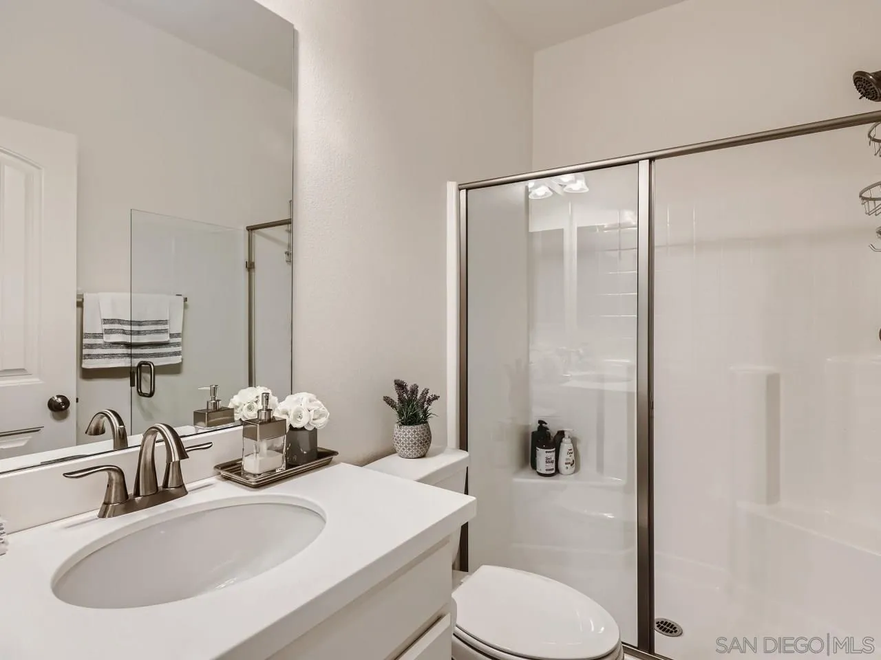 1263 Spivey Road Chula Vista, CA 91913 - Photo 13 of 26 a bathroom with a sink toilet and shower