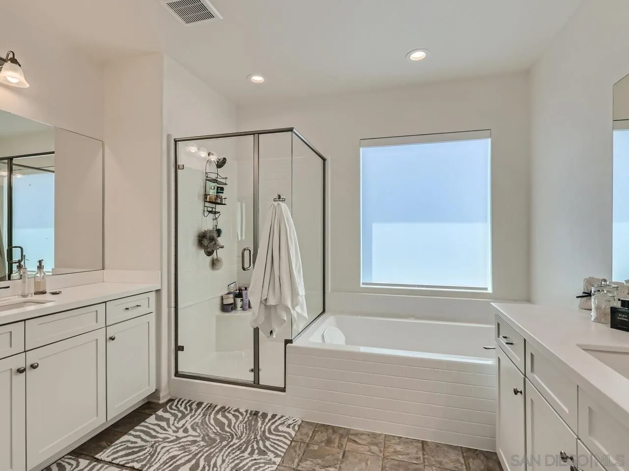 1263 Spivey Road Chula Vista, CA 91913 - Photo 16 of 26 a bathroom with a granite countertop sink a mirror a bathtub and shower