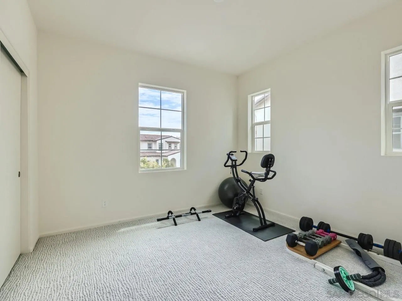 1263 Spivey Road Chula Vista, CA 91913 - Photo 17 of 26 a room with gym equipment and windows