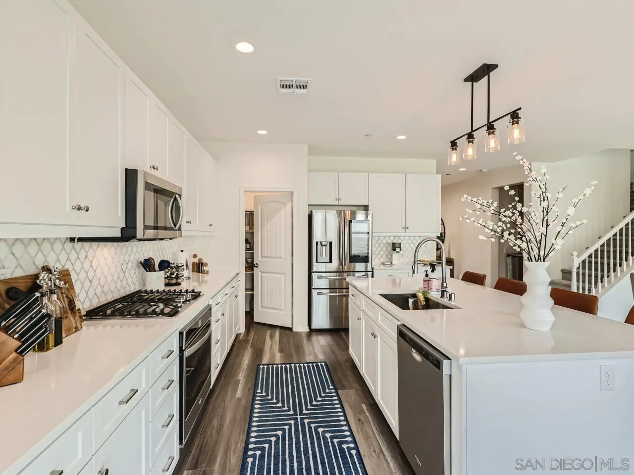 1263 Spivey Road Chula Vista, CA 91913 - Photo 5 of 26 a kitchen with a sink stove and refrigerator